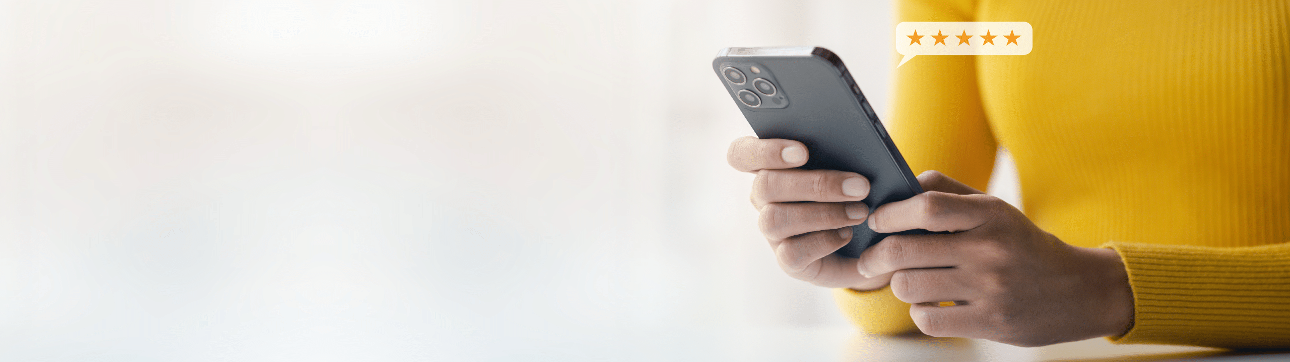 A person in a yellow sweater holding a smartphone, with a speech bubble displaying a five-star rating above the device, symbolizing trust and high customer satisfaction.
